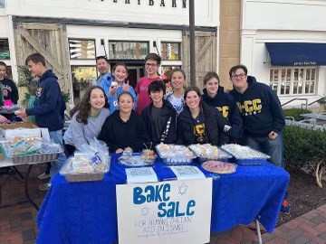 Members of the JSU and adult volunteers sell baked goods to raise funds in order to benefit Israeli civilians. 