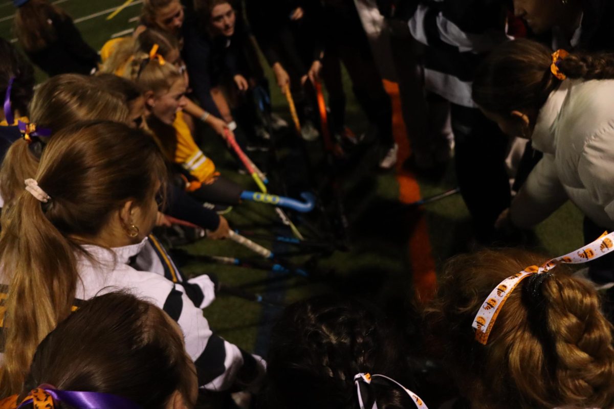 The Girls Varsity Field Hockey team huddles in the last moments of their playoff game against Whitman.