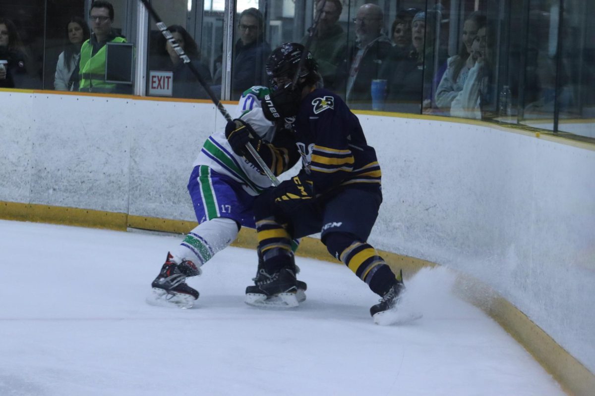 Senior Colin Eccles battles it out with Churchill for control of the puck