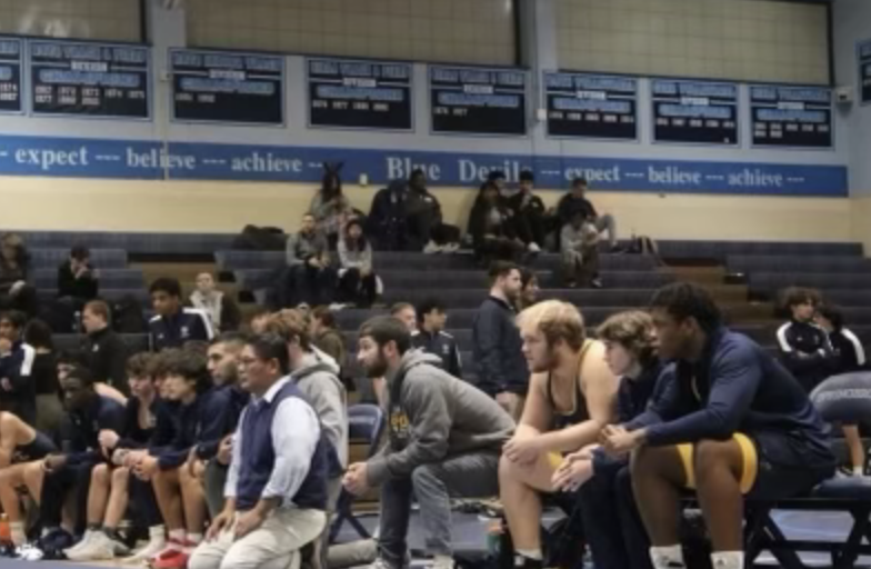 B-CC+Wrestling+Team+watches+the+match+from+the+bench.