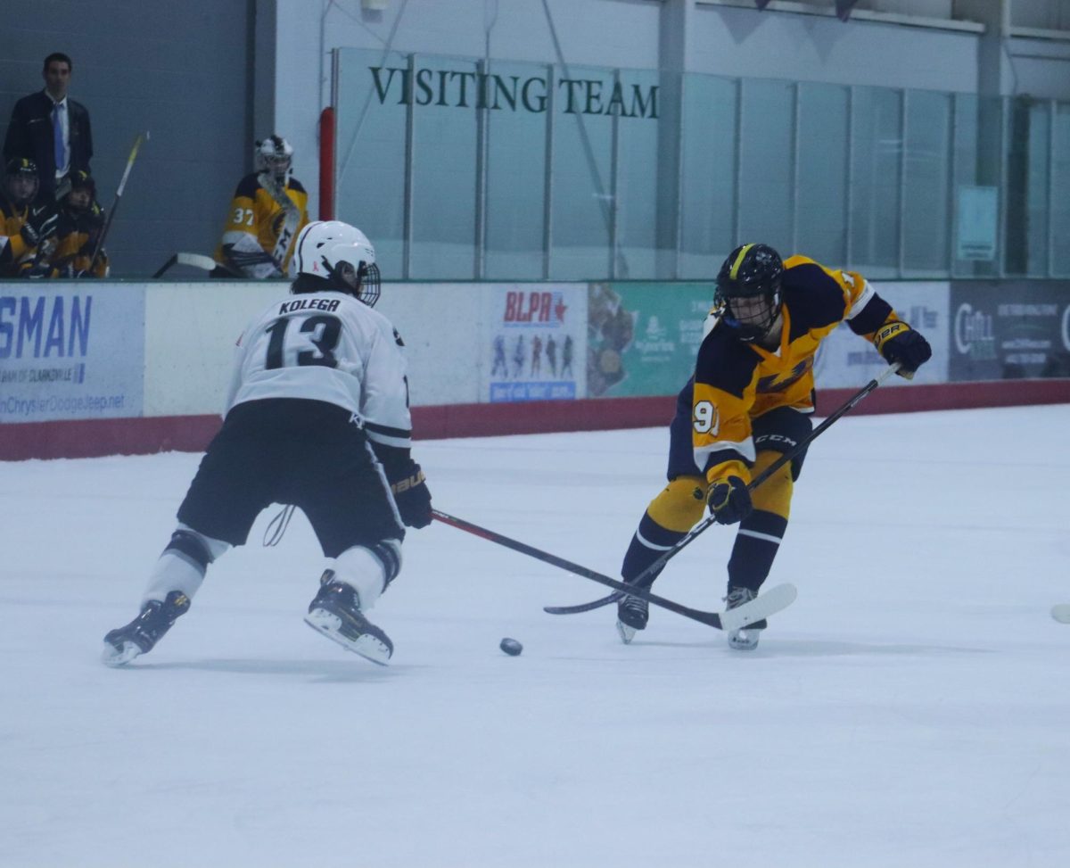 The B-CC Barons fight for the puck against the Oakdale Bears