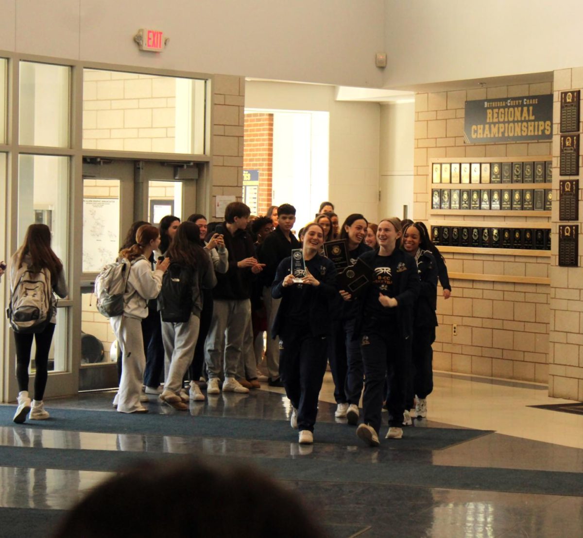 Girls Varsity Basketball parades through the halls while onlookers cheered, before heading to the semifinals. 