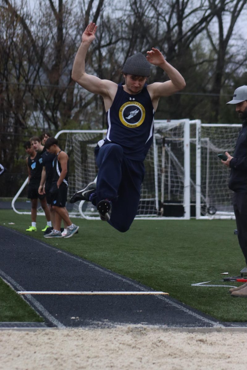 Senior Hewitt Grissom flies through the air during a track and field meet at B-CC.