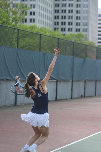 Junior Ivy Mcconarty serves against whitman at singles 1.