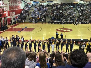 The B-CC POMs team hypes up the crowd with the Baron mascot. 