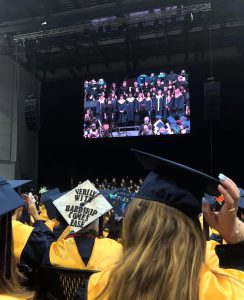Baron graduates watch their fellow classmates' choir performance.