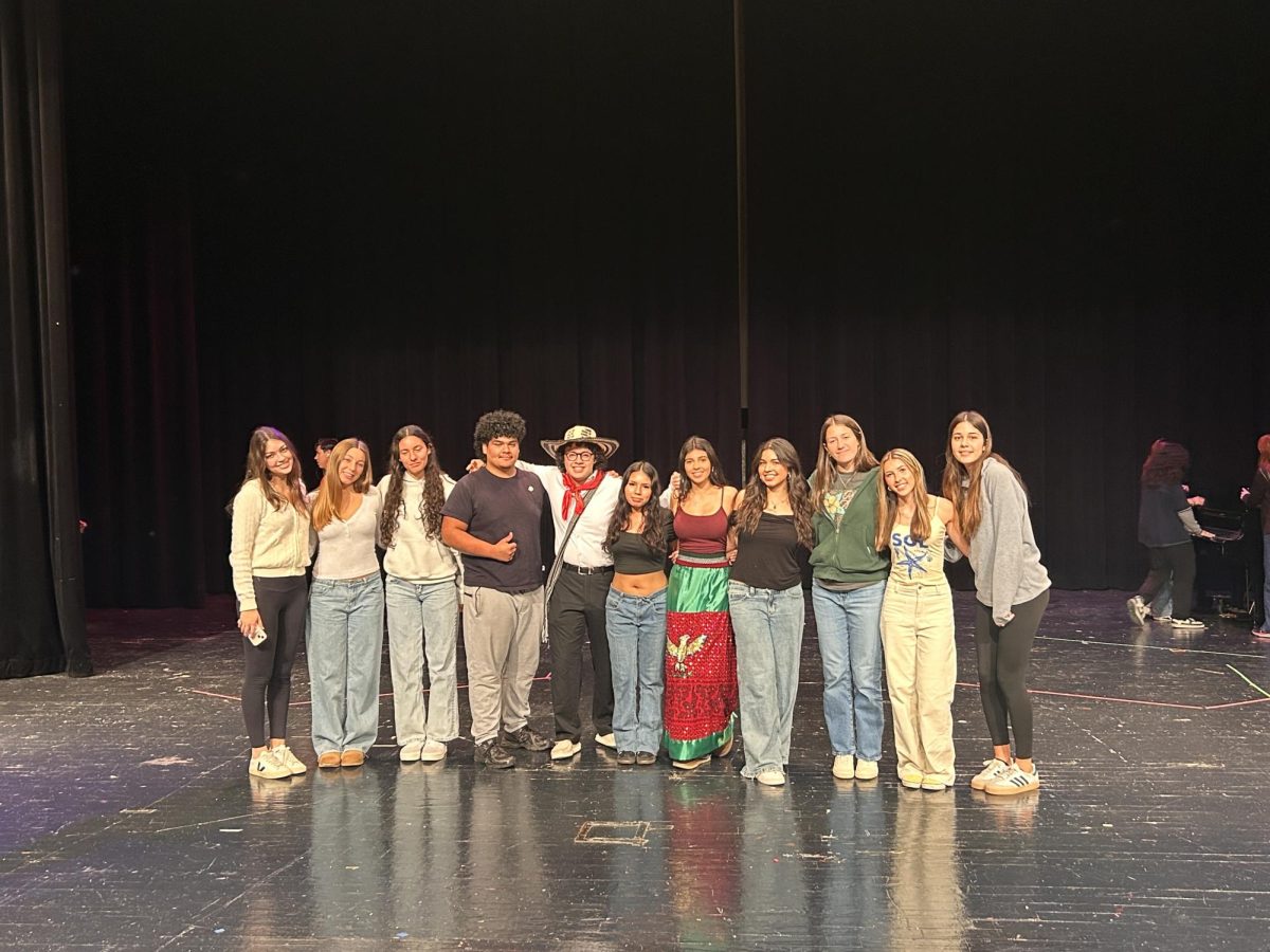 Performers, speakers, dancers, and other participants gather at the Hispanic Heritage Month Assembly.