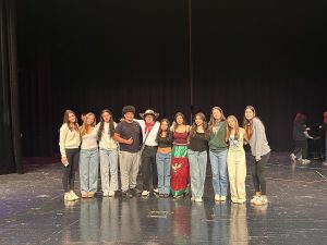 Performers, speakers, dancers, and other participants gather at the Hispanic Heritage Month Assembly.
