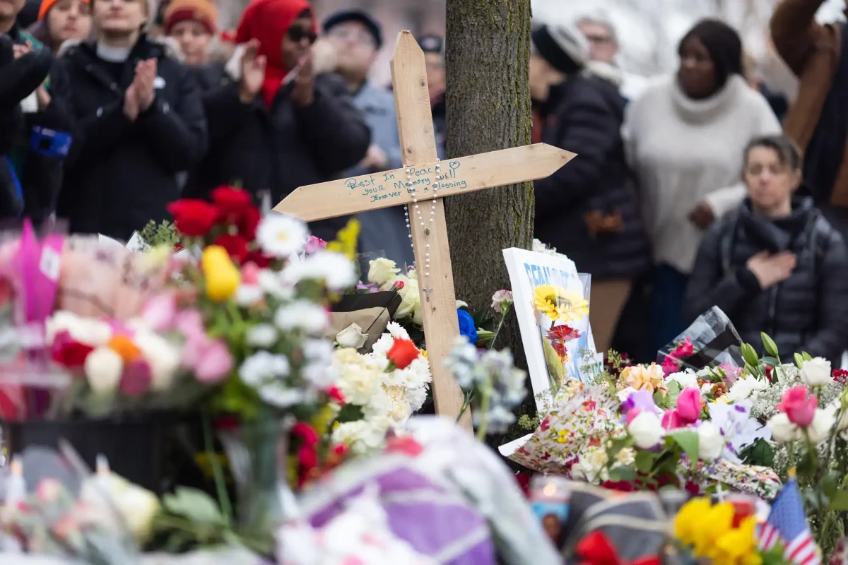 A cross adorns memorial for Renee Good in Minneapolis on Thursday, January 15. (Image Courtesy of Ben Hovland/MPR News)