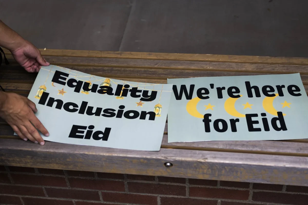Posters read messages for inclusion of Eid. One reads: “Equality Inclusion Eid,” outside of the school district’s L.E. Scarr Resource Center in Redmond on May 30, 2023. (Image Courtesy of Daniel Kim / The Seattle Times)