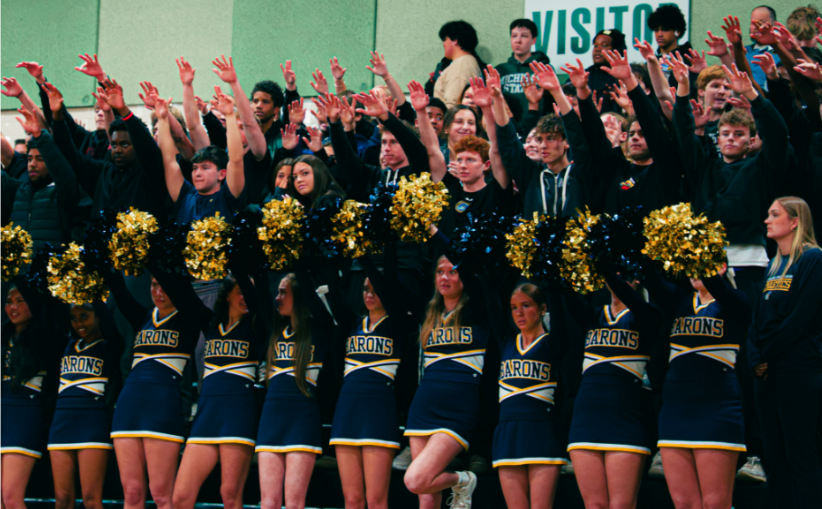 Shows an engaged student section at a B-CC boys basketball game 